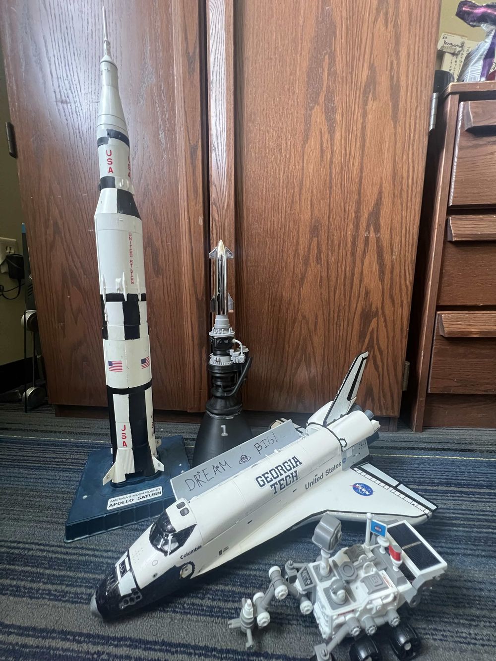 Models of a Saturn V, a Starship, a Space Shuttle and a rover